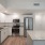 kitchen area on wooden floor with spacious counter-space and designer appliances