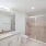 bathroom area with a sink, shelves and a stylish faucet