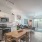 spacious kitchen and living room with easy access to other rooms and on wood-style flooring