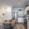 kitchen area on wooden floor with spacious counter-space and designer appliances